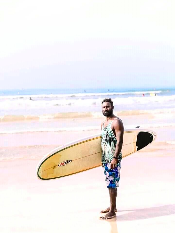 Suresh with surfboard on Weligama Beach